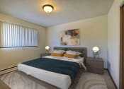 Thumbnail 4 of 14 - a bedroom with a large bed and a window. Fargo, ND Spring Apartments