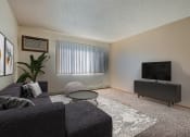 Thumbnail 2 of 10 - a living room with a couch and a tv. Fargo, ND Sterling Park Apartments