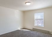 Thumbnail 29 of 43 - an empty room with carpet and a window. Fargo, ND Stonebridge Apartments