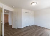 Thumbnail 34 of 43 - a bedroom with white walls and wood flooring. Fargo, ND Stonebridge Apartments