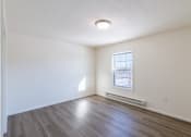 Thumbnail 33 of 43 - a bedroom with white walls and a window. Fargo, ND Stonebridge Apartments