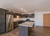 Thumbnail 27 of 43 - a kitchen with stainless steel appliances and a marble counter top. Fargo, ND Stonebridge Apartments