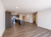 Thumbnail 25 of 43 - an empty living room and kitchen with wood flooring. Fargo, ND Stonebridge Apartments