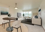 Thumbnail 2 of 21 - a living room with a couch and a table and a television. Fargo, ND Sunrise North