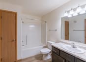 Thumbnail 19 of 20 - a bathroom with sink toilet and shower. Fargo, ND Sunwood Apartments