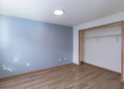 Thumbnail 18 of 20 - a room with a door to a closet and a hard wood floor. Fargo, ND Sunwood Apartments