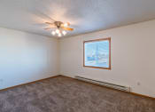 Thumbnail 8 of 20 - a bedroom  with a window and ceiling fan.  Fargo, ND Sunwood Apartments  | Living and kitchen Fargo, ND Sunwood Apartments
