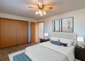 Thumbnail 2 of 20 - a bedroom with a large bed and a ceiling fan. Fargo, ND Sunwood Apartments