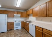 Thumbnail 5 of 20 - a kitchen with white appliances and wooden cabinets.  Fargo, ND Sunwood Apartments  | Living and kitchen Fargo, ND Sunwood Apartments