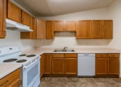 Thumbnail 6 of 20 - a kitchen with white appliances and wooden cabinets.  Fargo, ND Sunwood Apartments  | Living and kitchen Fargo, ND Sunwood Apartments