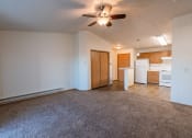 Thumbnail 4 of 20 - a living room with a kitchen and closet in the background. Fargo, ND Sunwood Apartments