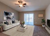 Thumbnail 1 of 20 - an open living room with a couch and a tv. Fargo, ND Sunwood Apartments