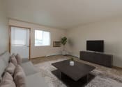 Thumbnail 1 of 28 - Fargo, ND Thunder Creek Apartments. The room is beautifully furnished with cozy seating, a coffee table, and stylish decor, creating a welcoming and relaxing environment. A small window brings natural light into the room.