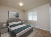 Thumbnail 6 of 28 - Fargo, ND Thunder Creek Apartments. A bedroom with a bed, window, and two nightstands