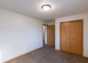 Thumbnail 24 of 28 - a bedroom with a closet door. Fargo, ND Thunder Creek Apartments