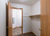 Thumbnail 22 of 28 - a bathroom with an open door and a closet. Fargo, ND Thunder Creek Apartments