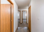 Thumbnail 26 of 28 - the view of a hallway with two doors and a door to a bedroom. Fargo, ND Thunder Creek Apartments