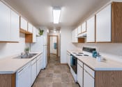 Thumbnail 20 of 28 - a kitchen with white cabinets and white appliances and a white counter top. Fargo, ND Thunder Creek Apartments