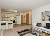 Thumbnail 5 of 16 - Fargo, ND Twin Parks Apartments. a living room with a white couch and a glass coffee table