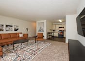 Thumbnail 2 of 16 - Fargo, ND Twin Parks Apartments. a living room with a brown couch and a black coffee table