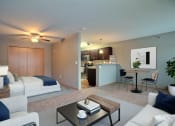 Thumbnail 6 of 45 - a living room and kitchen with a couch and a table. Fargo, ND Urban Plains Apartments