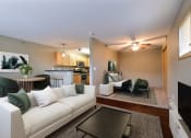 Thumbnail 7 of 45 - a living room with a white couch and a table. Fargo, ND Urban Plains Apartments
