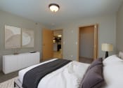 Thumbnail 3 of 45 - a bedroom with a bed and a door to a bathroom. Fargo, ND Urban Plains Apartments
