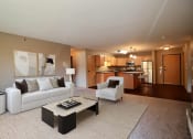Thumbnail 1 of 45 - a living room with a couch and a table. Fargo, ND Urban Plains Apartments