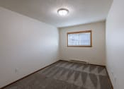 Thumbnail 20 of 26 - a bedroom with a window. Fargo, ND Village West Apartments
