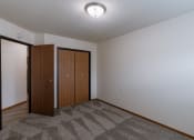 Thumbnail 23 of 26 - a bedroom with a closet. Fargo, ND Village West Apartment