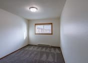 Thumbnail 22 of 26 - a bedroom with a window. Fargo, ND Village West Apartments