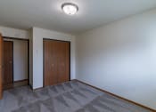 Thumbnail 21 of 26 - a bedroom with a closet. Fargo, ND Village West Apartments