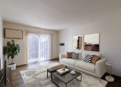 Thumbnail 6 of 26 - a living room with a couch and a coffee table. Fargo, ND Village West Apartments
