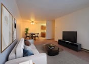Thumbnail 1 of 26 - a living room with a couch and a coffee table. Fargo, ND Village West Apartments