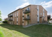 Thumbnail 26 of 26 - a brick apartment building with balconies. Fargo, ND Village West Apartments