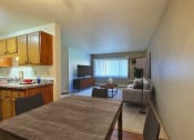 Thumbnail 2 of 11 - Fargo, ND Westcourt Apartments.  a kitchen and living room with a table and chairs
