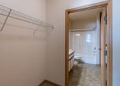 Thumbnail 14 of 61 - a bathroom with a shower and a toilet and a closet. Fargo, ND West Lake Apartments