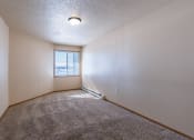 Thumbnail 10 of 61 - a bedroom with carpet and a window. Fargo, ND West Lake Apartments