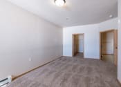 Thumbnail 11 of 61 - a bedroom with brown walls and carpet. Fargo, ND West Lake Apartments
