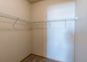Thumbnail 12 of 61 - a walk in closet with a white curtain and a wire rack on the wall. Fargo, ND West Lake Apartments