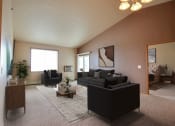 Thumbnail 4 of 61 - a living room with a couch and a table. West Fargo, ND West Lake Apartments.