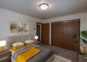 Thumbnail 5 of 9 - a bedroom with a bed and a closet. Fargo, ND West Oak Apartments