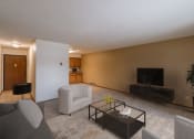 Thumbnail 3 of 9 - a living room with a couch and a coffee table. Fargo, ND West Oak Apartments