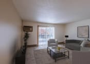 Thumbnail 2 of 9 - an apartment living room with a couch and a coffee table. Fargo, ND West Oak Apartments