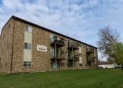 Thumbnail 1 of 9 - the exterior of a brick apartment building with balconies. Fargo, ND West Oak Apartments.