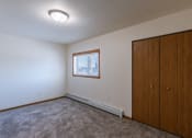 Thumbnail 39 of 42 - a bedroom with a closet and a window. Fargo, ND Westwood Apartments