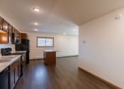 Thumbnail 36 of 42 - a kitchen with black appliances and a window with a dining room. Fargo, ND Westwood Apartments