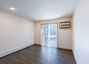 Thumbnail 32 of 42 - a living room with a glass sliding door. Fargo, ND Westwood Apartments
