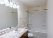 Thumbnail 30 of 42 - a bathroom with a sink and a toilet and a shower. Fargo, ND Westwood Apartments