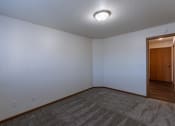 Thumbnail 29 of 42 - a bedroom with a door to the dining entry area. Fargo, ND Westwood Apartments